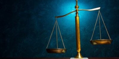 Justice scale on blue background VICTORY for Oil and Gas Producers on Severance Tax Dispute